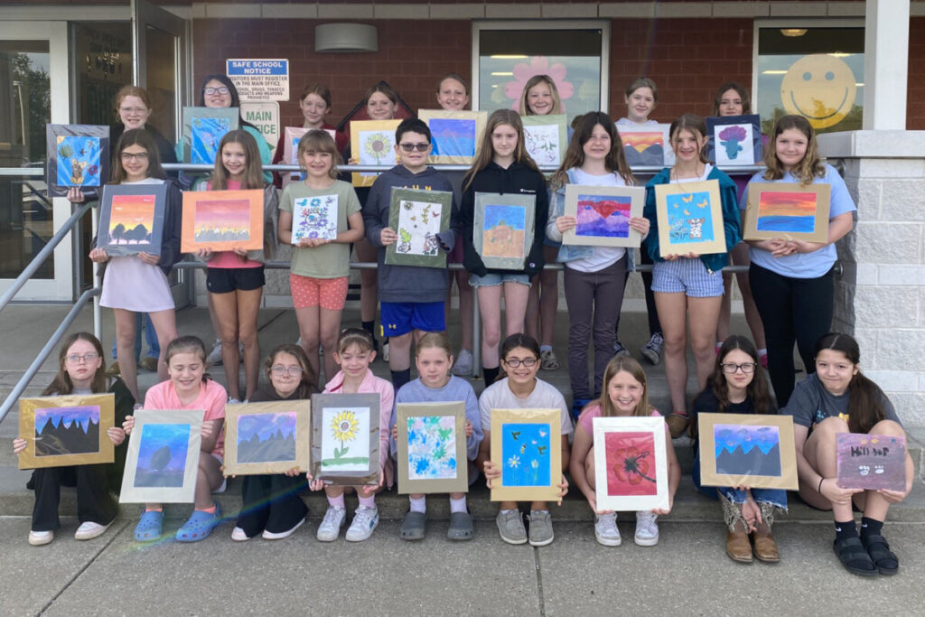 Hilltop Elementary Kindness Crew members are pictured with the paintings they created and donated to a local nursing home.