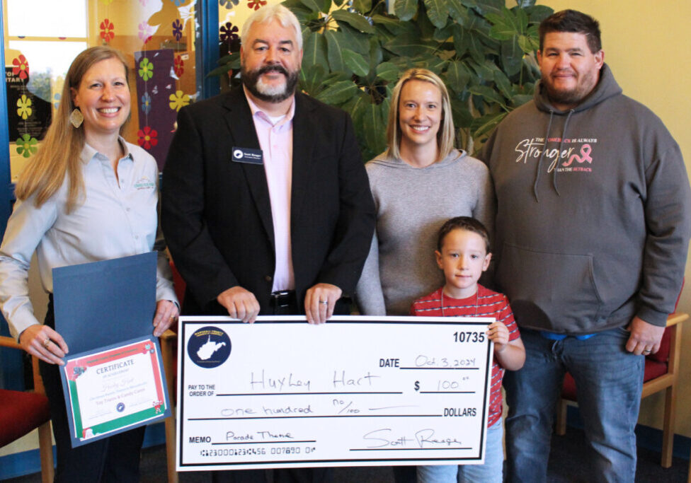 Huxley is pictured holding the large $100 check he was presented for winning the Chamber’s parade theme contest. Also pictured, standing behind him from left, are Marshall County Chamber of Commerce Board President Ashley Wear, Marshall County Chamber of Commerce Executive Director Scott Reager and Huxley’s parents Sarah and Justin Hart.